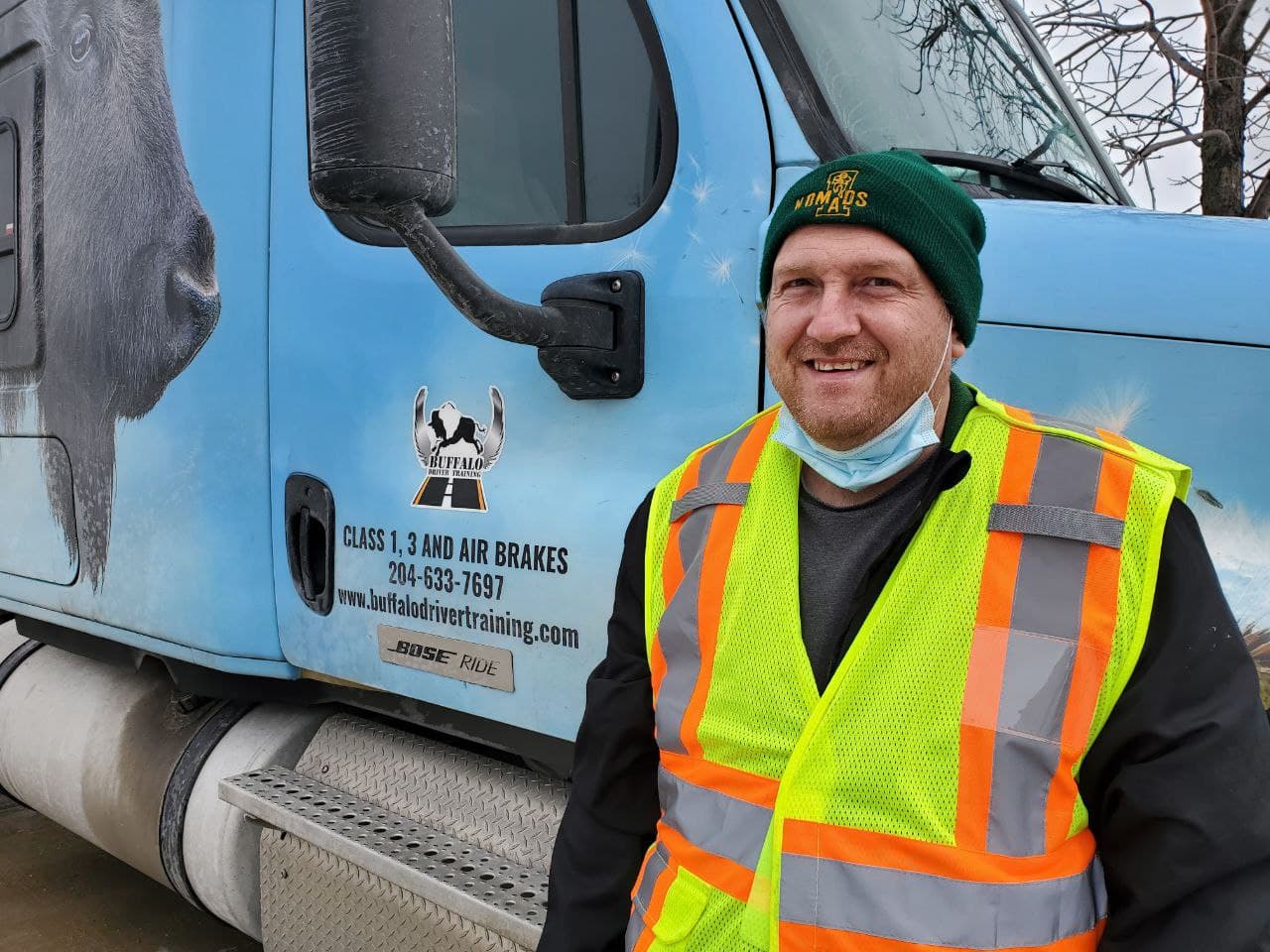 A driver beside a blue Buffalo training truck