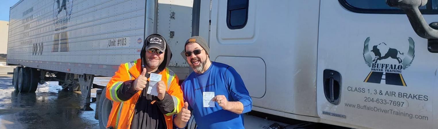 Two Buffalo students celebrating beside a training truck